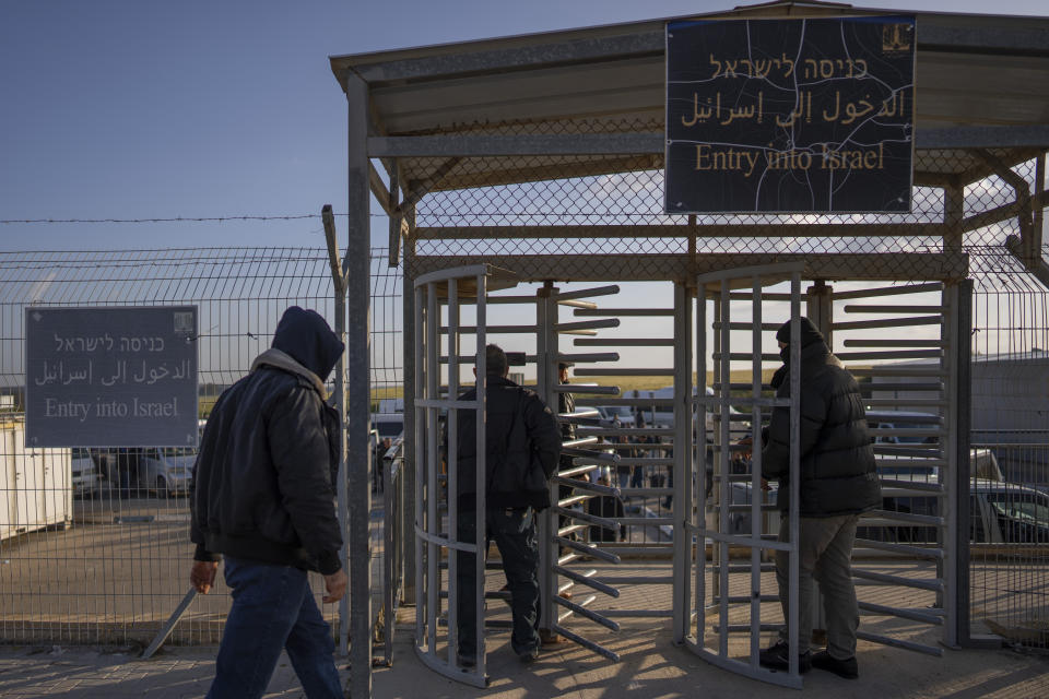 Palestinian workers enter Israel after crossing from Gaza on the Israeli side of Erez crossing between Israel and the Gaza Strip, March. 27, 2022. Israel said it will reopen its crossing with the Gaza Strip to Palestinian workers on Tuesday, April 26, 2022, after it had been closed for several days following rocket attacks from the Palestinian enclave. Israel has issued thousands of work permits to Palestinians from Gaza, which has been under a crippling Israeli and Egyptian blockade since Hamas seized power from rival Palestinian forces nearly 15 years ago. (AP Photo/Oded Balilty)