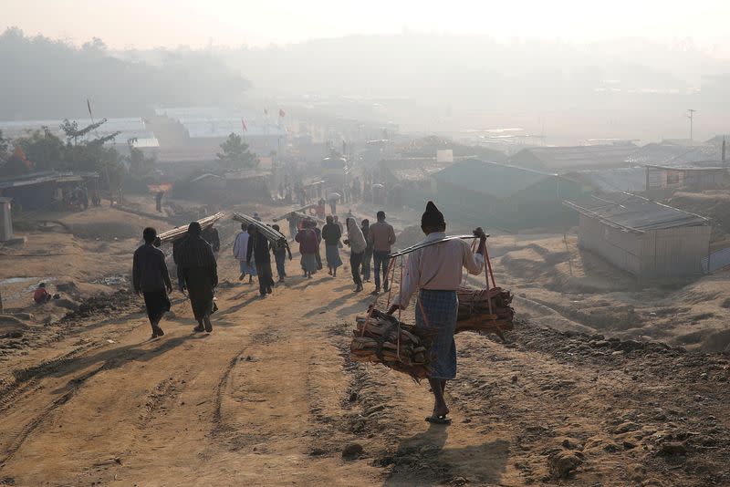 FILE PHOTO: Rohingya refugees walk at Jamtoli camp in the morning in Cox's Bazar