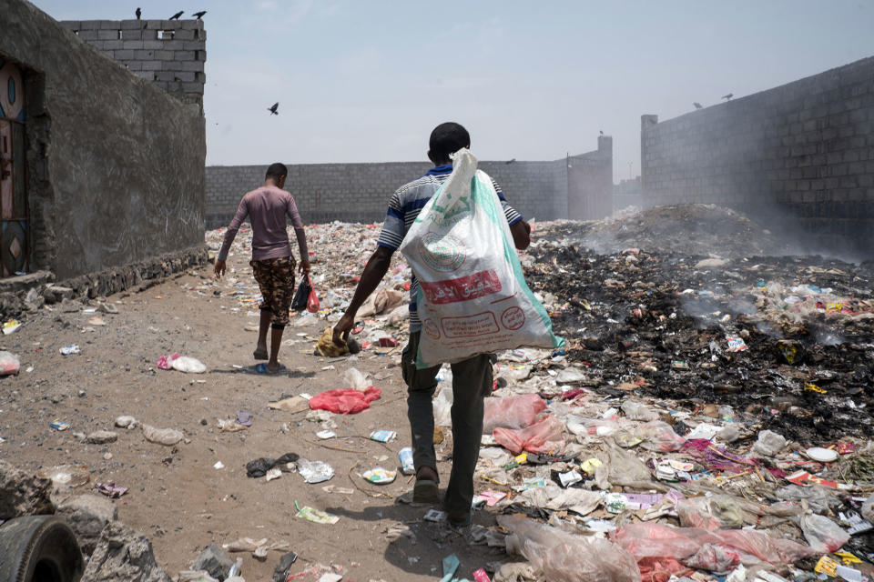 <p>Al Hudaydah, Yemen, April 18, 2017: Life in the backstreets of Al Hudaydah. Local recyclers scavenge through trash on a smoking street not far from the OCHA field office. (Photograph by Giles Clarke for UN OCHA/Getty Images) </p>