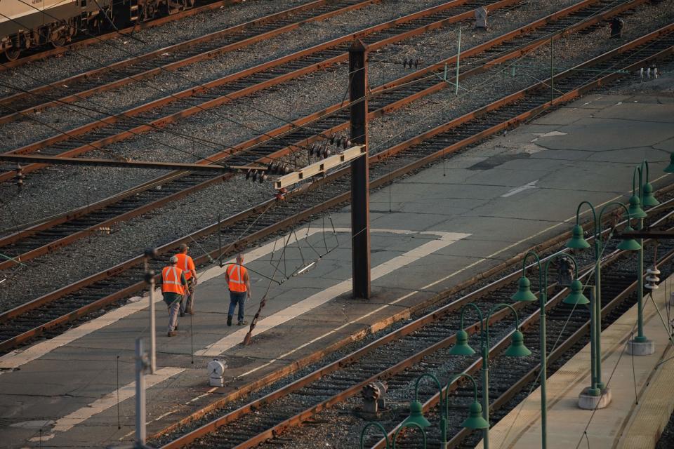 Railway workers walk through Union Station in Washington, DC, on September 15, 2022. - US rail companies and unions have reached a 