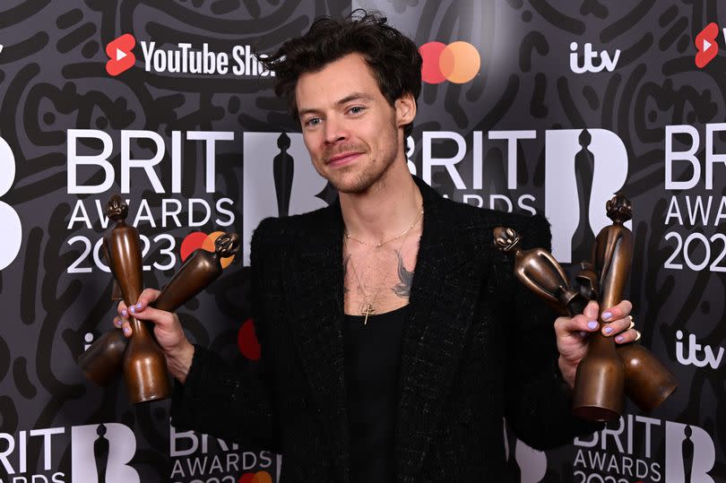 Harry Styles poses with the awards for British Pop/R&B Act, British Artist of the Year, Song of the Year and Album of the Year in the media room during The BRIT Awards 2023 at The O2 Arena on February 11, 2023 in London, England