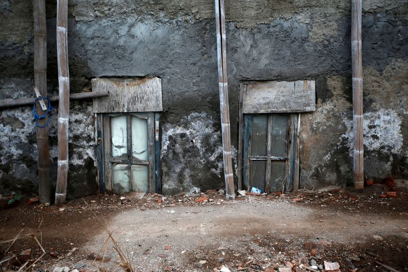 Windows of a house affected by land subsidence are pictured at Tambakrejo village in Semarang