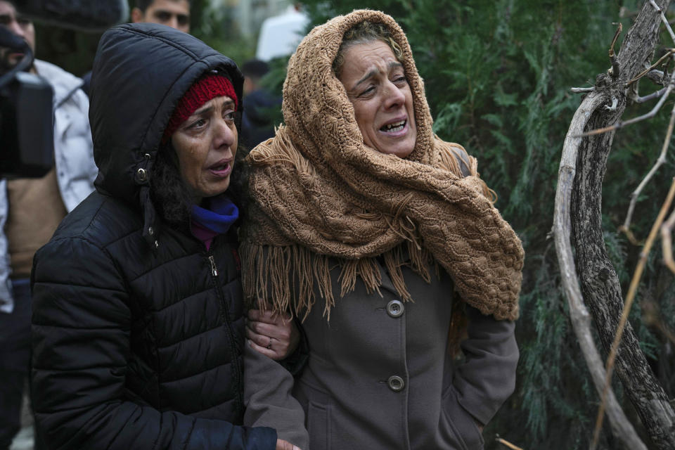 Women watch the rescue efforts in Adana, Turkey.  (Khalil Hamra / AP)