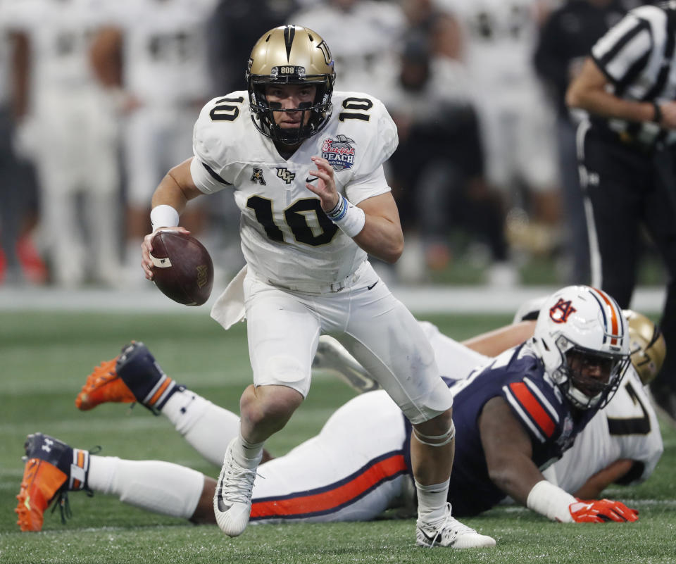 Central Florida quarterback McKenzie Milton (10) runs out of the pocket against Auburn during the first half of the Peach Bowl NCAA college football game, Monday, Jan. 1, 2018, in Atlanta. (AP Photo/John Bazemore)