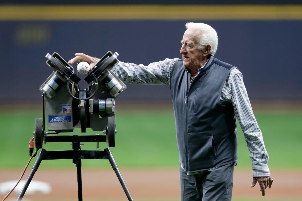 Bob Uecker throws out the first pitch using a pitching machine as he is honored for 50 years of broadcasting before the game at American Family Field on September 25, 2021 in Milwaukee, Wisconsin.