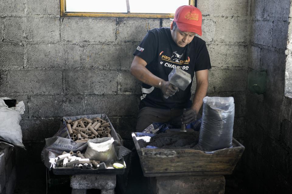Rafael Martinez works with gunpowder to make fireworks at his family's workshop in preparation for the annual festival in honor of Saint John of God, the patron saint of the poor and sick whom fireworks producers view as a protective figure, in Tultepec, Mexico, Tuesday, March 5, 2024. (AP Photo/Marco Ugarte)