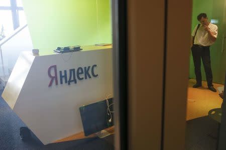 A man is seen through a glass door in the office of the Russian internet group Yandex in Kiev, Ukraine, May 29, 2017. REUTERS/Valentyn Ogirenko