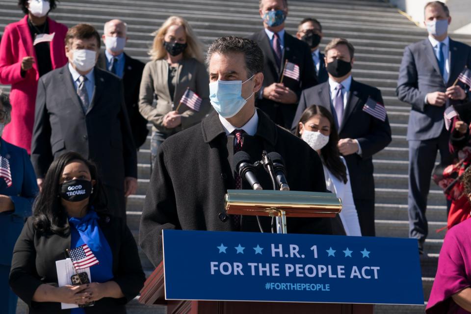 HR 1 sponsor John Sarbanes speaks with lawmakers ahead of a vote on the bill on 3 March.AP