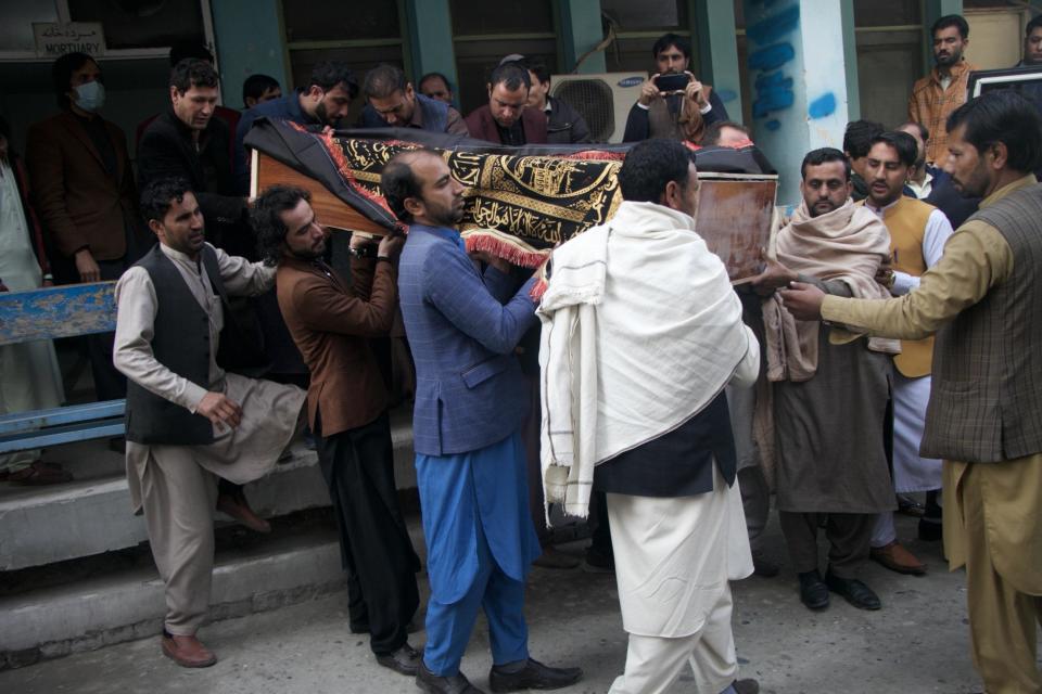 People attend the funeral ceremony of Malalai Maiwand, a journalist at Enikass Radio and TV in Nangarhar, after she was killed along with her driver in an attack on their vehicle in Jalalabad, December 10, 2020, in Jalalabad, Afghanistan. / Credit: Wali Sabawoon/Anadolu Agency/Getty