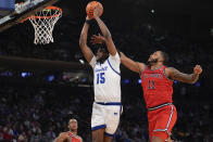 Seton Hall's Jaden Bediako (15) dunks the ball in front of St. John's Joel Soriano (11) during the first half of an NCAA college basketball game in the quarterfinal round of the Big East Conference tournament, Thursday, March 14, 2024, in New York. (AP Photo/Frank Franklin II)