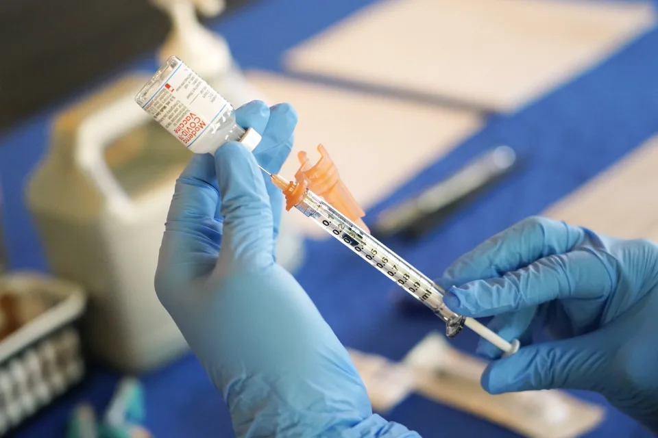 A Jackson-Hinds Comprehensive Health Center nurse prepares a syringe of a Moderna COVID-19 vaccine at an inoculation station next to Jackson State University in Jackson, Miss., Tuesday, July 19, 2022. (AP Photo/Rogelio V. Solis)