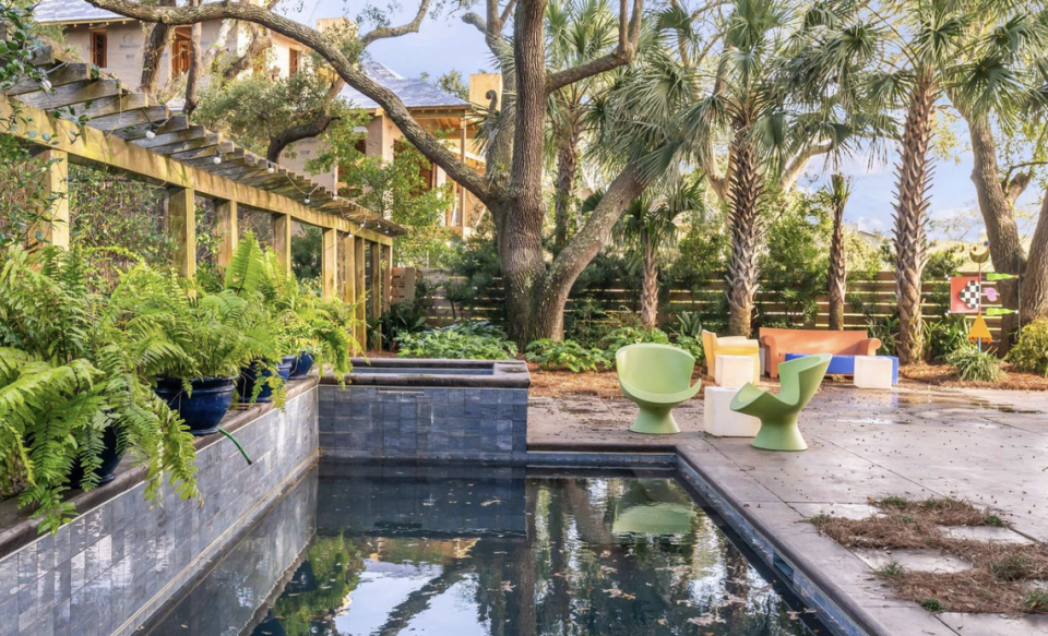 The house includes a pool and spa amid a private patio.