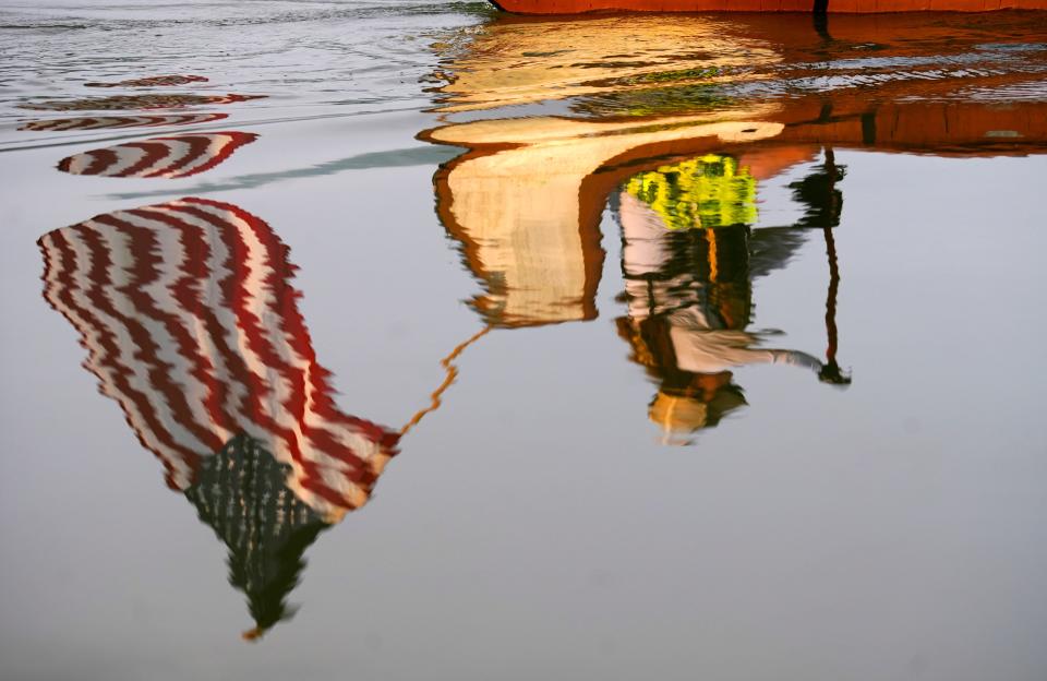 The reflection of Kathy Voughn, of Franklin, Ohio, is mirrored in the still water of the Ohio River during the Ohio River Challenge. Voughn and others were paddling from Daniel J. Gilday Recreation Complex in Riverside to Rising Sun, Ind., a 33-mile journey as part of a ten-day, 250 mile adventure that started in Portsmouth and ends in Louisville. The event promotes outdoor recreation and celebrates the history of the river. Paddlers are in 30 ft. Voyageur canoes, built in the style French trappers used in the late 1700’s.