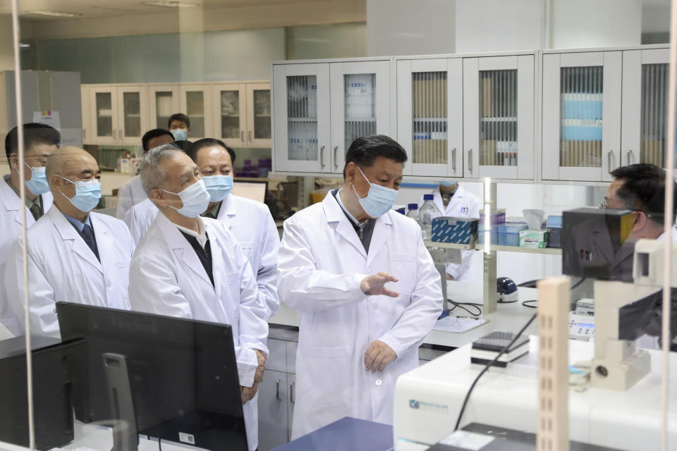 In this March 2, 2020, photo released by Xinhua News Agency, Chinese President Xi Jinping learns about the progress on the research into COVID-19 vaccine candidates during a visit to the Academy of Military Medical Sciences in Beijing. With national pride at stake in the global race for a coronavirus vaccine, Xi pledged that any Chinese-made vaccine would be a "global public good." (Ding Haitao/Xinhua via AP)