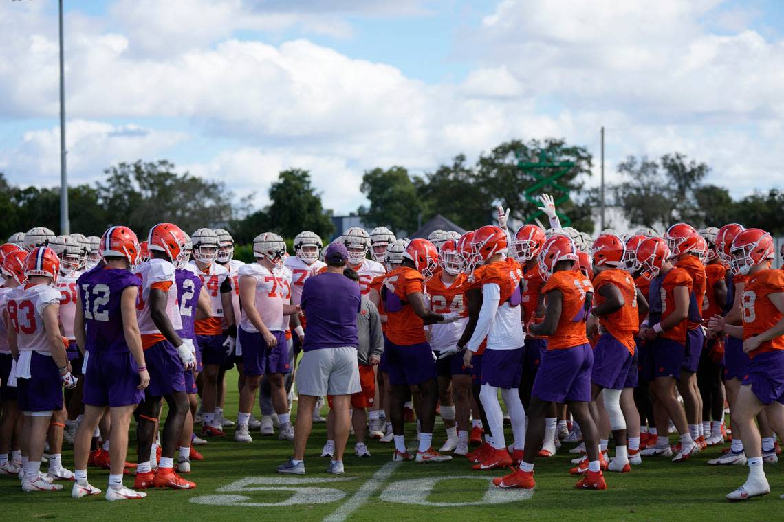 Clemson Tigers players gather around head coach Dabo Swinney, center, during a practice session ahead of the 2022 Orange Bowl, Wednesday, Dec. 28, 2022, in Fort Lauderdale, Fla. Clemson will face the Tennessee Volunteers in the Orange Bowl on Friday, Dec. 30. (AP Photo/Rebecca Blackwell)