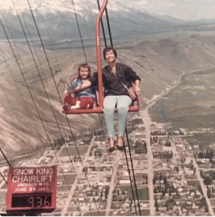 a mother and daughter on a ski lift