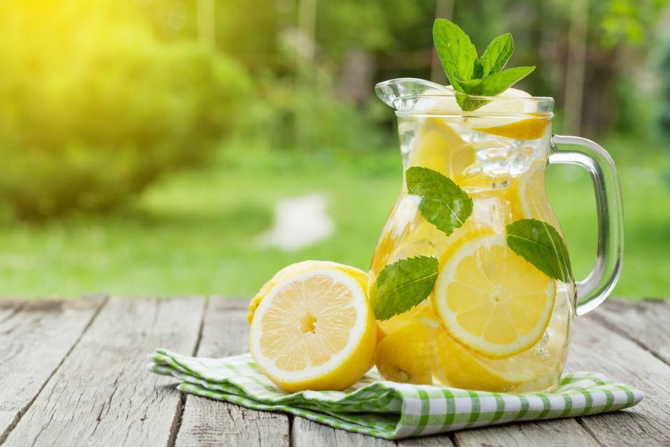 summer activities pitcher of lemonade with lemon, mint and ice