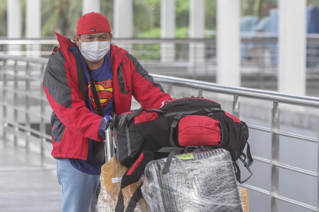 FILE PHOTO: An Overseas Filipino Worker (OFW) arrive at Ninoy Aquino International Airport Terminal 2 in Pasay, Metro Manila, Philippines on December 18, 2020. (Photo by Dante Diosina Jr/Anadolu Agency via Getty Images)