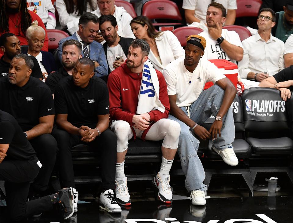 Apr 29, 2024; Miami, Florida, USA; Miami Heat forward Kevin Love (42) and Jimmy Butler (22) watch the Heat fall to the Boston Celtics during the fourth quarter of game four of the first round for the 2024 NBA playoffs at Kaseya Center. Mandatory Credit: Michael Laughlin-USA TODAY Sports