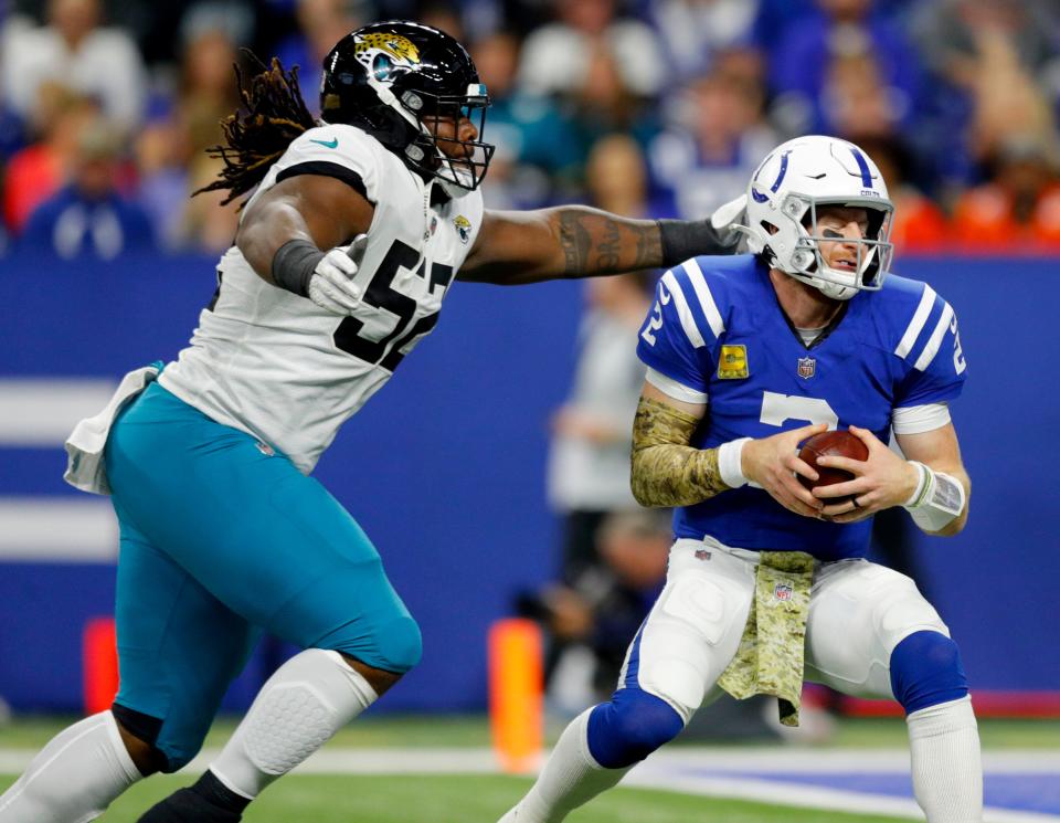 Jacksonville Jaguars defensive tackle DaVon Hamilton (52) sacks Indianapolis Colts quarterback Carson Wentz (2) on Sunday, Nov. 14, 2021, during a game against the Jacksonville Jaguars at Lucas Oil Stadium in Indianapolis.