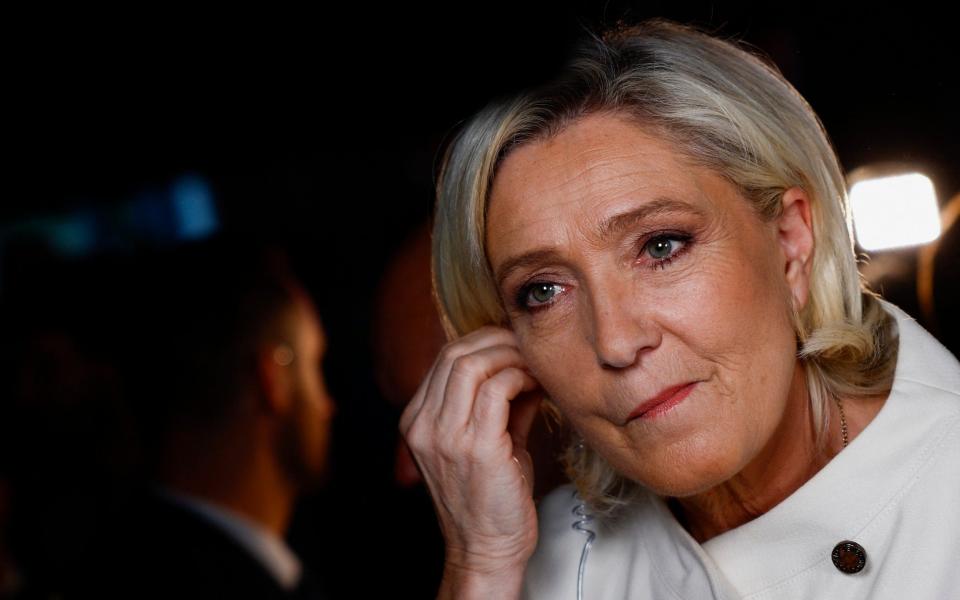 Marine Le Pen looks sombre as she prepares to speak to journalists after the exit poll results