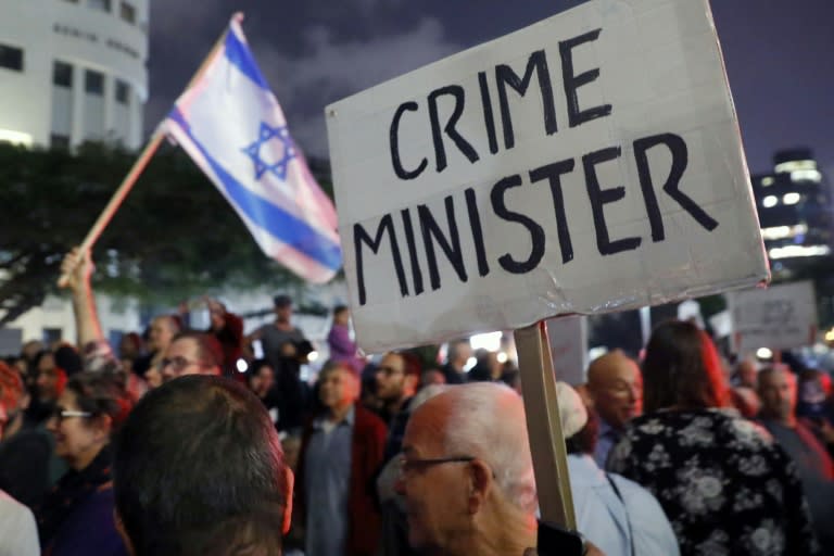 Israelis take part in a "March of Shame" against alleged corruption in Prime Minister Benjamin Netanyahu's government in Tel Aviv on December 23, 2017