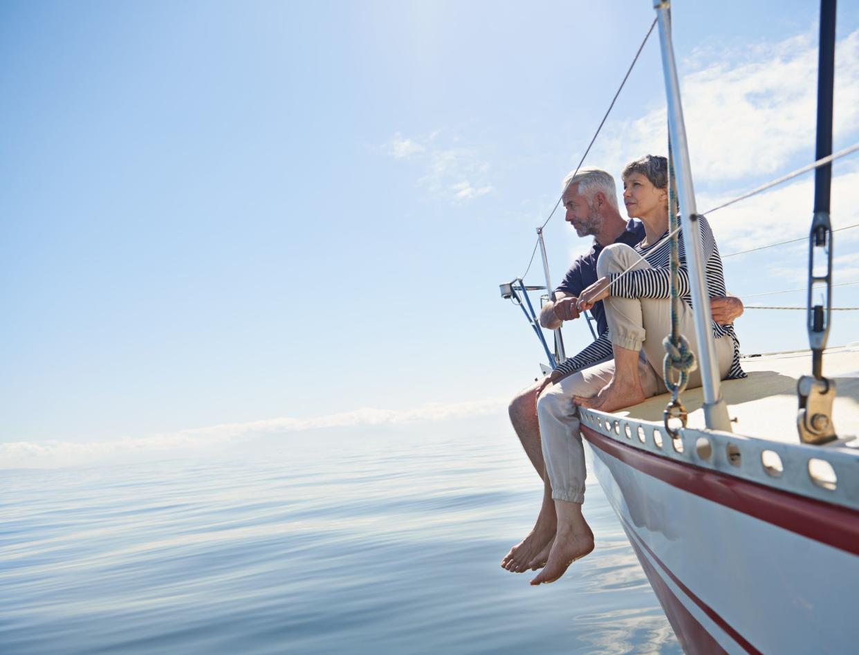 Shot of a loving mature couple on a sailboat looking out onto the ocean