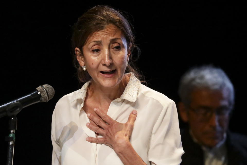 Former Colombian presidential candidate Ingrid Betancourt, who was abducted while campaigning by the Revolutionary Armed Forces of Colombia rebels, is overcome by emotion as she speaks during an event at the Truth Commission to commemorate victims of the country’s decades-long armed conflict, in Bogota, Colombia, Wednesday, June 23, 2021. (AP Photo/Ivan Valencia)