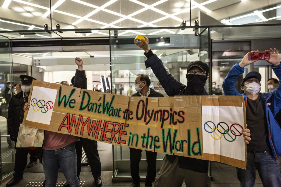 TOKYO, JAPAN - MARCH 25: Demonstrators protest against the Tokyo Olympics outside the building of the Tokyo Organising Committee of the Olympic and Paralympic Games on March 25, 2021 in Tokyo, Japan. Japan's nation-wide torch relay for the postponed Tokyo 2020 Olympics started on Thursday in Fukushima ahead of the opening ceremony in Tokyo scheduled for July 23. (Photo by Yuichi Yamazaki/Getty Images)