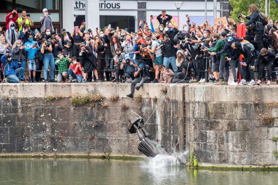 The statue of 17th century slave trader Edward Colston falls into the water after protesters pulled it down and pushed into the docks, during a protest against racial inequality in the aftermath of the death in Minneapolis police custody of George Floyd, in Bristol, Britain, June 7, 2020.(Keir Gravil via Reurters)