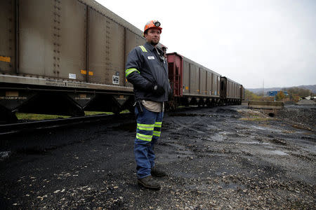 Greg Carpenter, 35, stands by as coal from rail cars is unloaded at the Murray Energy Corporation port facility in Powhatan Point, Ohio, U.S., November 7, 2017. REUTERS/Joshua Roberts