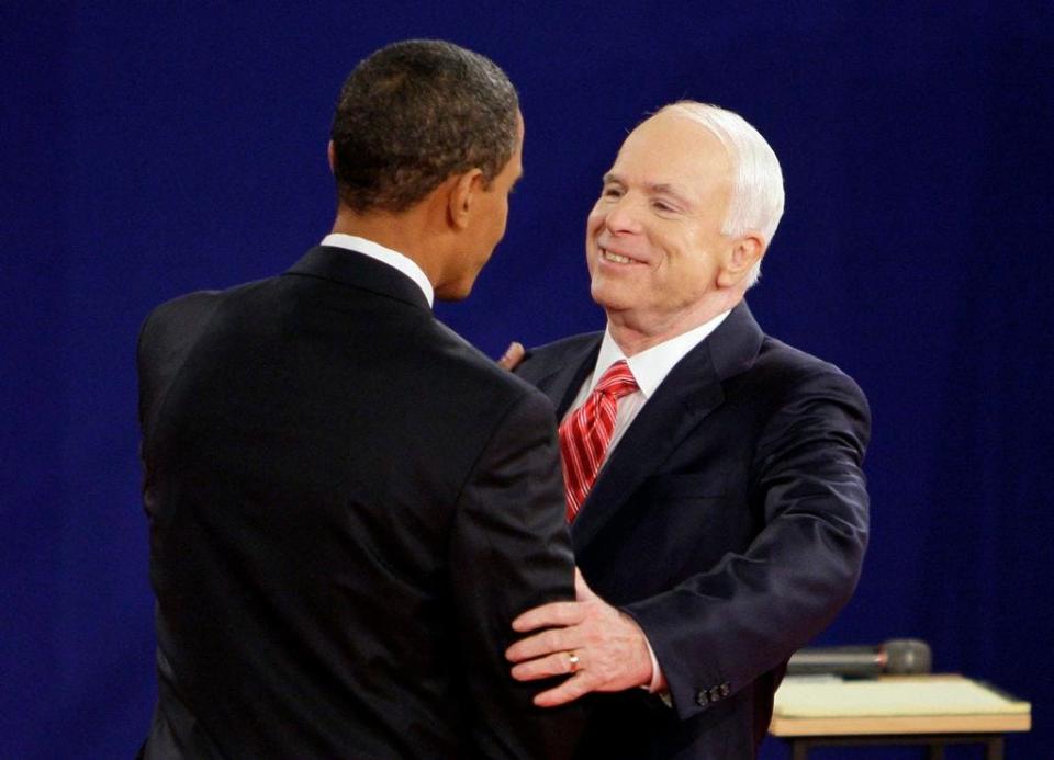 FILE - In this Oct. 7, 2008, file photo, Democratic presidential candidate Sen. Barack Obama, D-Ill., left, and Republican presidential candidate Sen. John McCain, R-Ariz., greet each other at the start of a townhall-style presidential debate at Belmont University in Nashville, Tenn. Aide says senator, war hero and GOP presidential candidate McCain died Saturday, Aug. 25, 2018. He was 81. (AP Photo/Mark Humphrey, File)