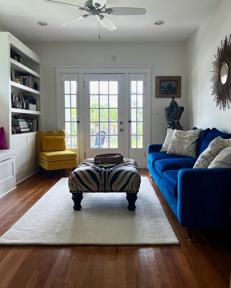 Blue velvet sofa in newly renovated living room.