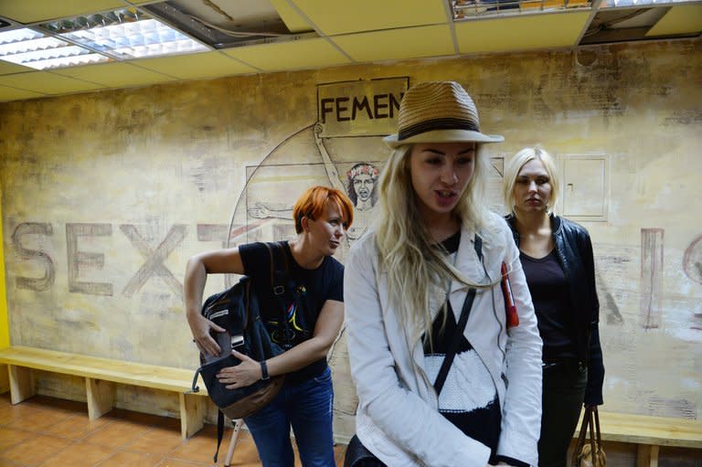 Activists from the Ukrainian feminist group FEMEN, Anna Hutsol (left), Oleksandra Shevchenko and Yana Zhdanova, stand in their office in Kiev on August 27, 2013. Ukrainian feminist movement Femen said Wednesday it was moving out of its Kiev offices, alleging official wiretapping, a day after police said they discovered a cache of illegal weapons in a raid of its premises