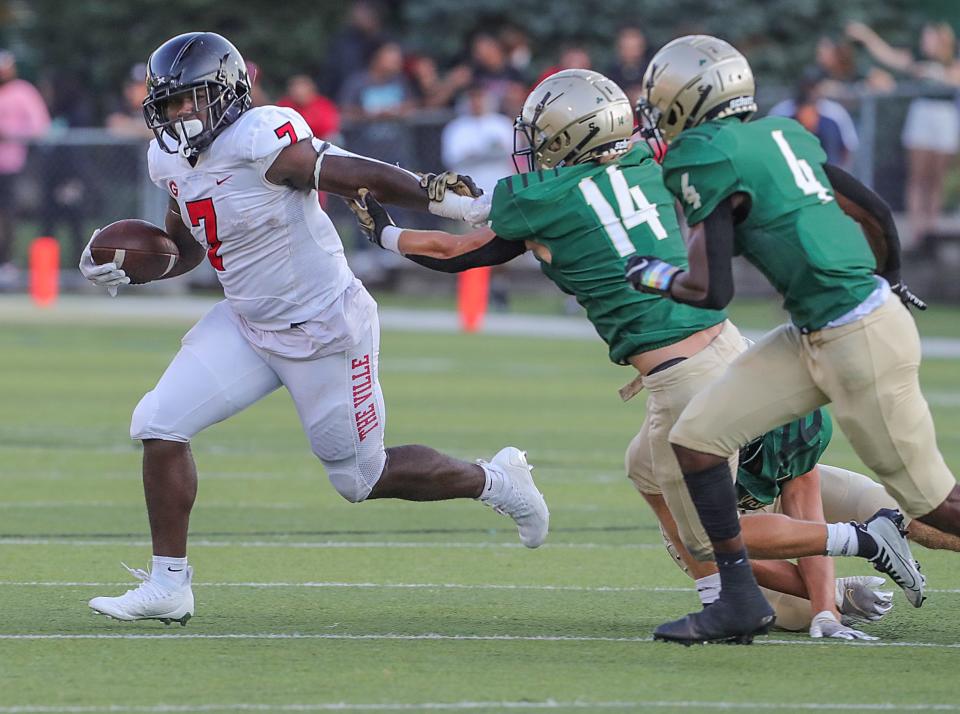 Glenville running back D'Shawntae Jones gets past the St. Vincent-St. Mary defense during the first quarter on Thursday, Aug. 18, 2022 in Akron, Ohio, at John Cistone Field.