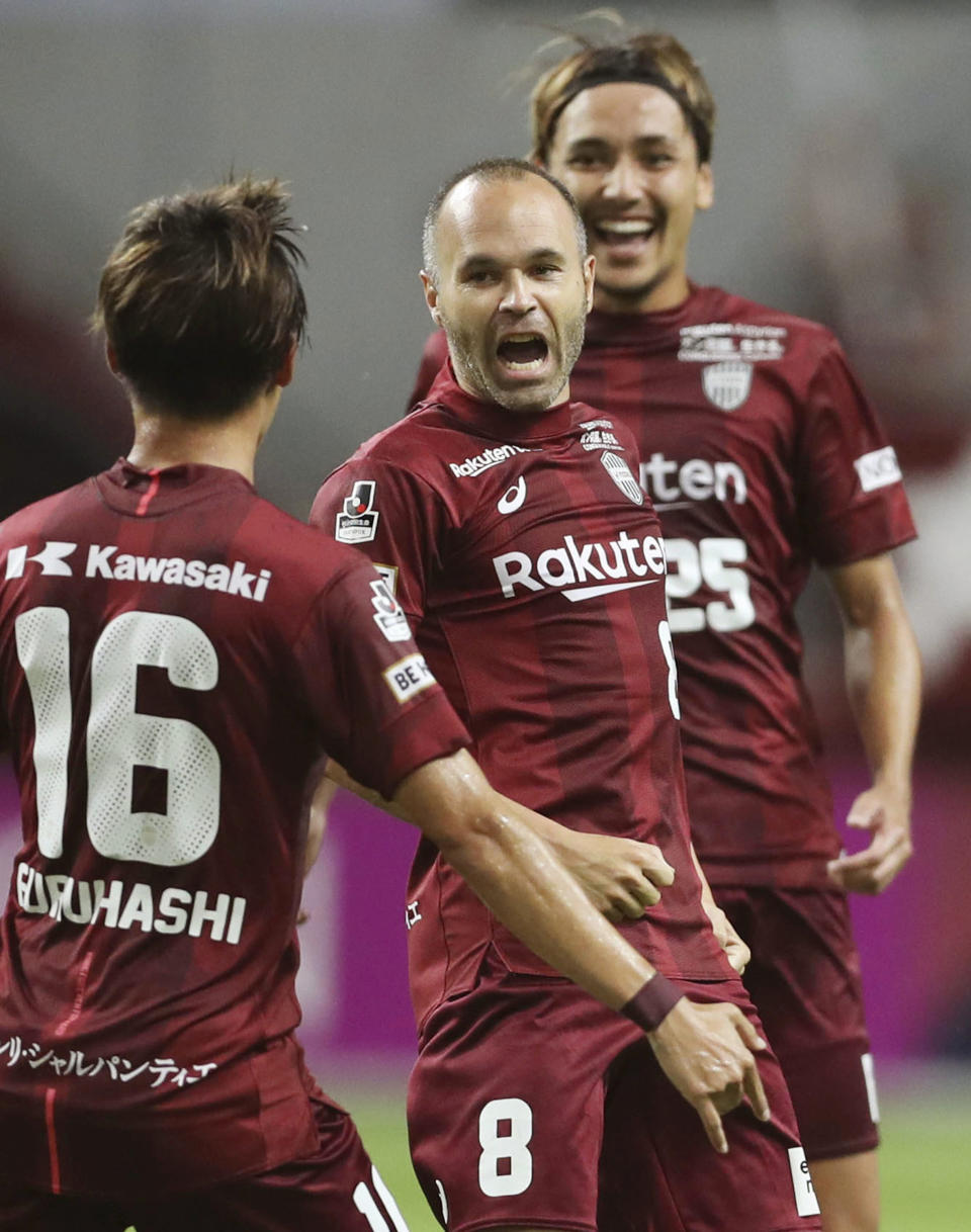 Vissel Kobe's Andres Iniesta, center, celebrates his game-tying goal during a J-League soccer match against Sanfrecce Hiroshima in Kobe, western Japan Wednesday, Aug. 15, 2018. (Takumi Sato/Kyodo News via AP)