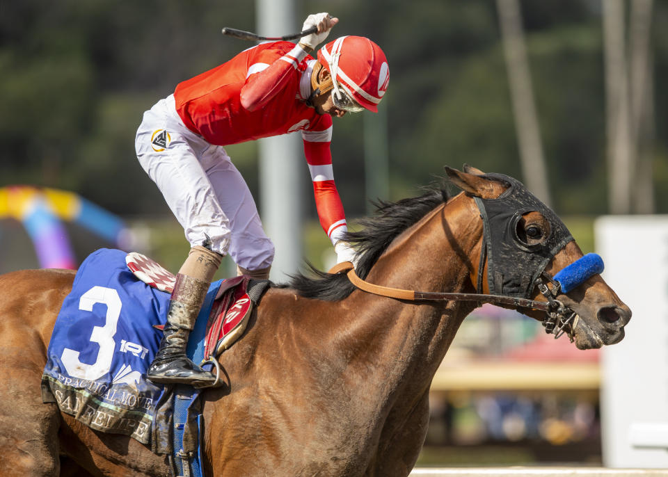 In this image provided by Benoit Photo, Jockey Ramon Vazquez celebrates aboard Practical Move after winning the Grade II $400,000 San Felipe Stakes horse race, Saturday, March 4, 2023 ,at Santa Anita Park in Arcadia, Calif. (Benoit Photo via AP)