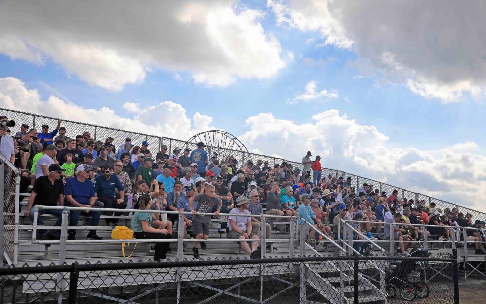 Fans watch from the bleachers near the East Horseshoe in the infield portion of the Daytona road course.