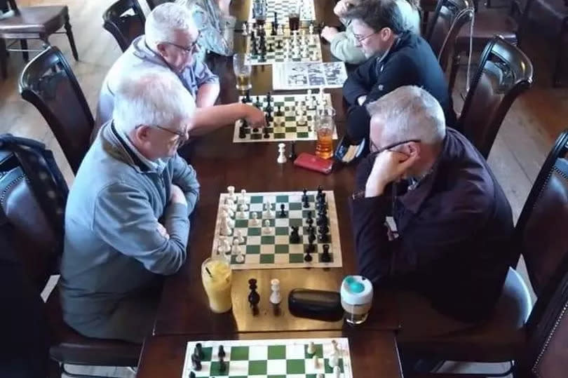 Adult members of Downpatrick Chess Club during a session at Denvir's Coaching Inn