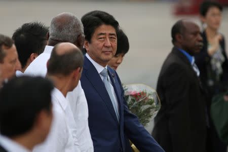 Japan's Prime Minister Shinzo Abe (C), talks to Cuban authorities upon his arrival at the Jose Marti International Airport in Havana, Cuba, September 22, 2016. REUTERS/Alexandre Meneghini