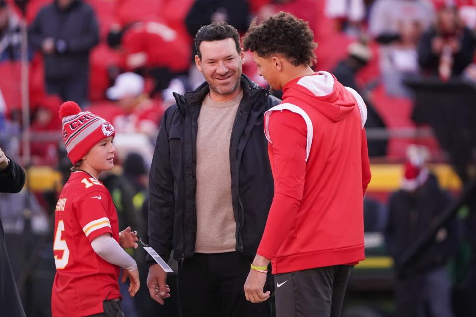 Kansas City Chiefs quarterback Patrick Mahomes talks with former NFL quarterback and CBS broadcaster Tony Romo and Romo's son Rivers prior to a game against the Buffalo Bills at Arrowhead Stadium.