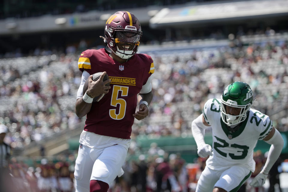 Washington Commanders quarterback Jayden Daniels (5) scores on a touchdown run past New York Jets cornerback Isaiah Oliver (23) during the first half of an NFL preseason football game Saturday, Aug. 10, 2024, in East Rutherford. N.J. (AP Photo/Pamela Smith)