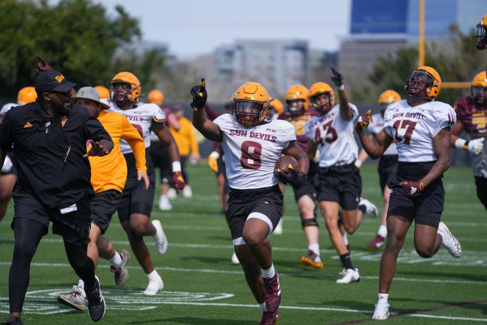 Sun Devils wide receiver Javen Jacobs (8) runs to the end zone after intercepting a pass during an ASU football practice at Kajikawa Football Practice Fields on Saturday, March 18, 2023, in Tempe.