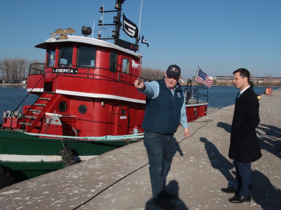 Port of Monroe Director Paul LaMarre, left, talks with Secretary of Transportation Pete Buttigieg during a tour of the port Wednesday, Nov. 23, 2023. Behind them is the tug boat America.