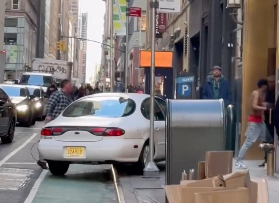 The driver chased after the shirtless pedestrian (right) before jumping out of his car. WhatIsNewYork/Instagram