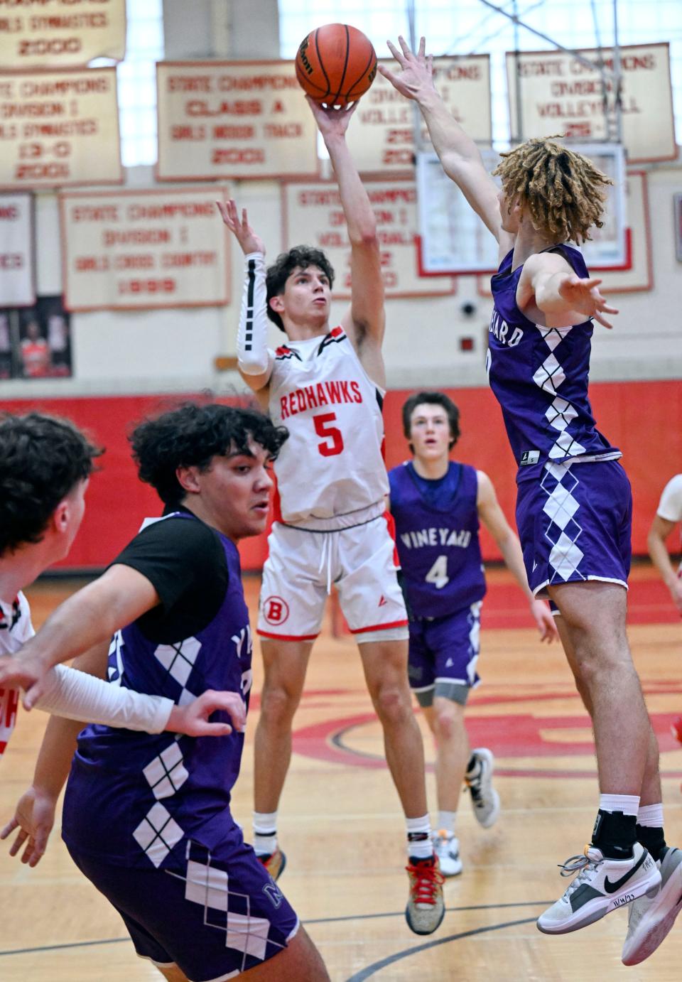 HYANNIS 12/27/23 Rafael Vasconcelos of Barnstable boys basketball shoots over Tysean Thomas of Martha's Vineyard. 
Ron Schloerb / Cape Cod Times