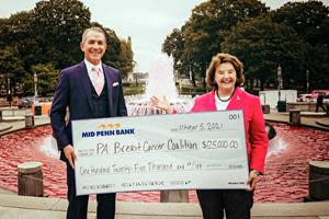 Mid Penn Bank raised $125,000 for the Pennsylvania Breast Cancer Coalition through the sixth annual Mid Penn Bank Celebrity Golf Classic for Breast Cancer Charity. Rory Ritrievi, President and CEO of Mid Penn Bank, presents the contribution to Pat Halpin-Murphy, President and Founder of the PBCC.