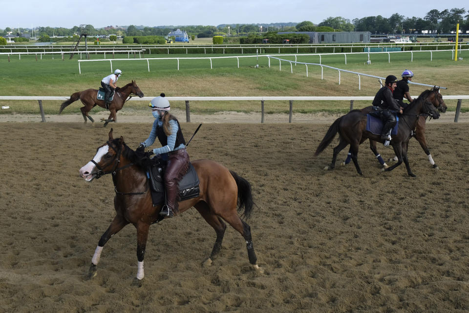 Riders and horses participate in work outs at Belmont Park in Elmont, N.Y., Friday, June 19, 2020. The Belmont Stakes is scheduled to run on Saturday. (AP Photo/Seth Wenig)