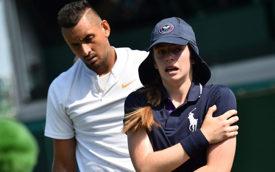 Australia's Nick Kyrgios consoles a ballgirl after she was hit by a ball - AFP