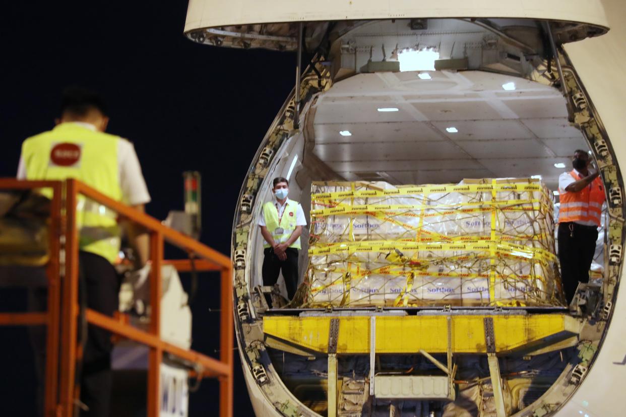 The first batch of Pfizer-BioNTech COVID-19 vaccines being unloaded from the plane upon its arrival in Singapore. (PHOTO: Ministry of Communication and Information)